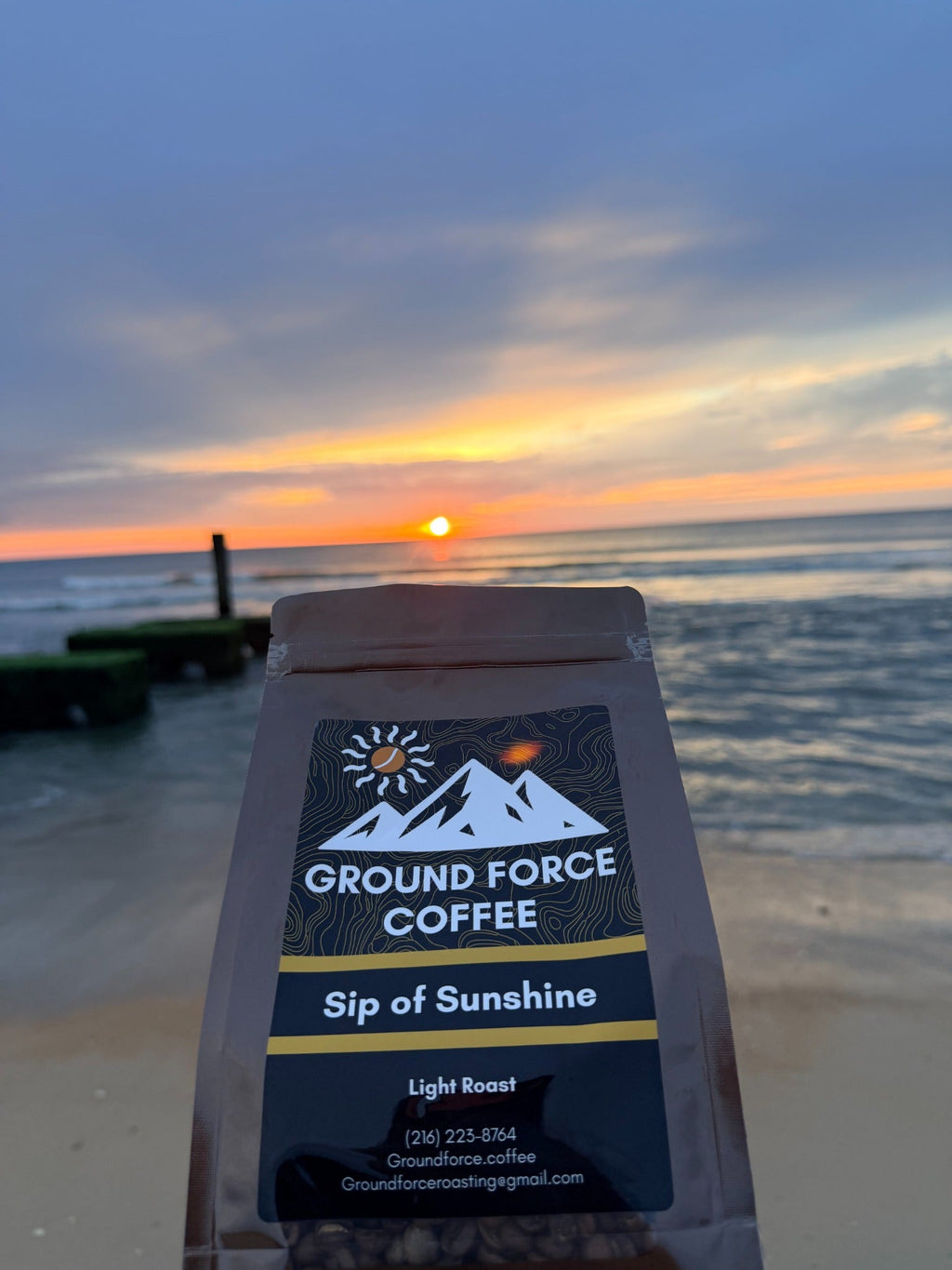 Sip of Sunshine coffee bag on the beach at sunrise